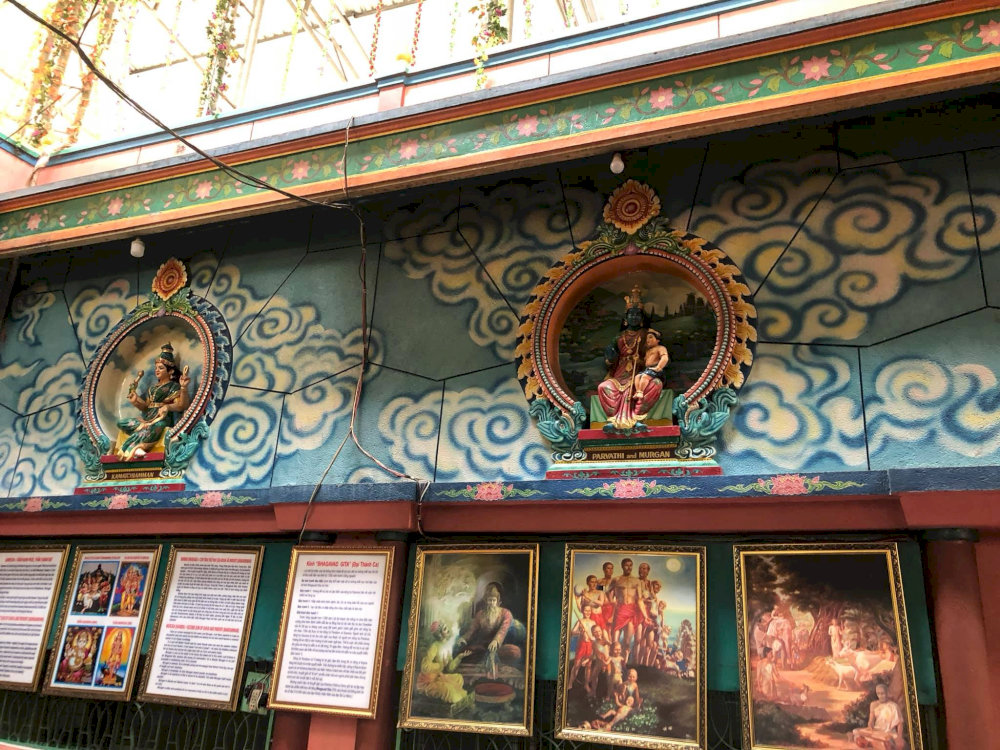 A row of Hindu deity statues along the temple wall, each representing unique spiritual meanings 